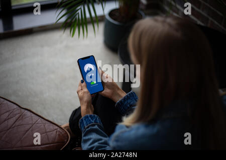 Woman holding a smartphone in the office Stock Photo