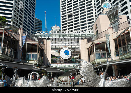 16.09.2018, Sydney, New South Wales, Australia - Cockle Bay Wharf at Darling Harbour with the Dancing Brolga Fountain and the business district in the