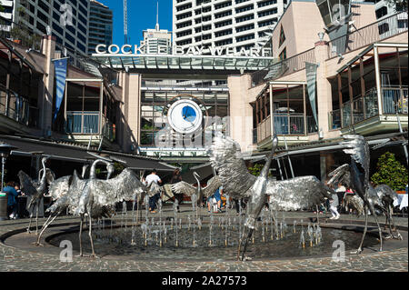16.09.2018, Sydney, New South Wales, Australia - Cockle Bay Wharf at Darling Harbour with the Dancing Brolga Fountain and the business district in the