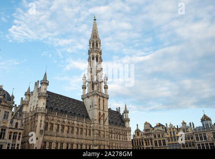 Facade of Brussels City Hall in Grand Place. Taken at dawn with few people in the square Stock Photo