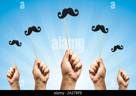 Hands holding Photo booth props, Black Mustache and rising them up Stock Photo