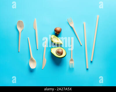 Avocado Seeds Biodegradable Single-Use Cutlery. Bioplastic - Great alternative to plastic disposable cutlery. Minimal concept on blue background. Stock Photo