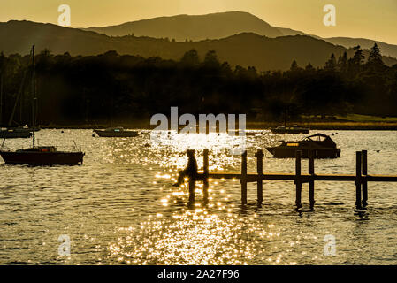 Evening sunshine on Lake Windermere at Ambleside pier. Stock Photo