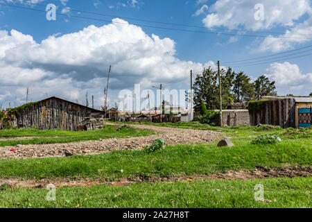 Nanyuki, Laikipia County, Kenya – June 19th, 2019: Landscape photograph of stone track surrounded by typical small Kenyan homes in Nanyuki outskirts. Stock Photo