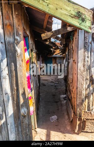 Nanyuki, Laikipia County, Kenya – June 19th, 2019: Colour photograph of tiny alleyway within typical Kenyan slum in Nanyuki outskirts. Stock Photo