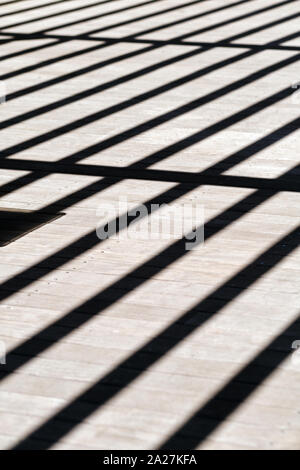 Graphic abstract shadow lines on a clean modern stone architecture flooring Stock Photo