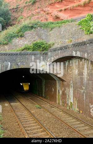 An up Great Western Intercity Express train emerging from Kennaways tunnel at Dawlish, headed by power car No 802003. 1st September 2019. Stock Photo