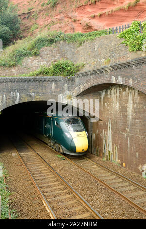 An up Great Western Intercity Express train emerging from Kennaways tunnel at Dawlish, headed by power car No 802003. 1st September 2019. Stock Photo