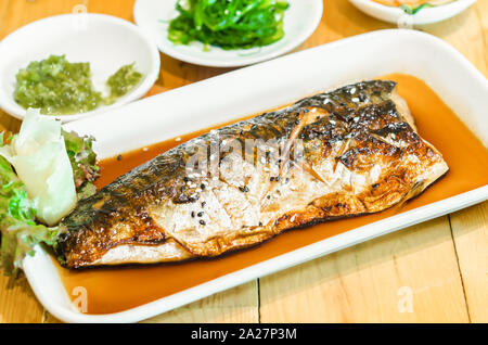 Saba or mackerel fish grilled with soy sauce with black and white sesame on japanese food table. Stock Photo