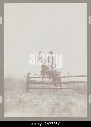 President Theodore Roosevelt on horseback jumping over rail Stock Photo