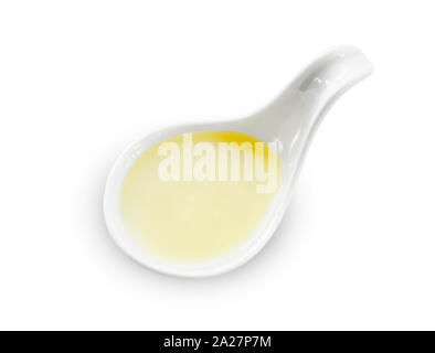 sweetened condensed milk in white spoon isolated on white background, save clipping path. Stock Photo