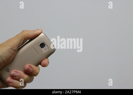 Bangkok, Thailand - October 1, 2019 : Closeup camera of obsolete nokia cellphone in one hand, it has 3.2 megapixels resolution Stock Photo