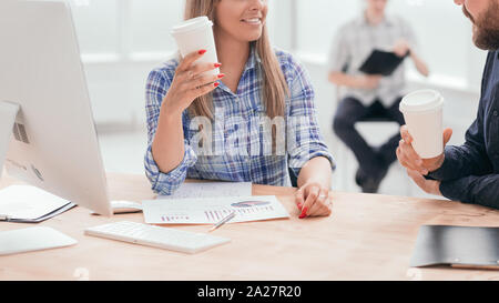smiling staff discussing business document during coffee break Stock Photo