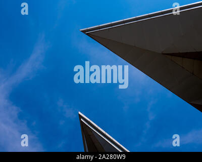 Triangle shapes of the roof of the modern building and bright blue sky Stock Photo