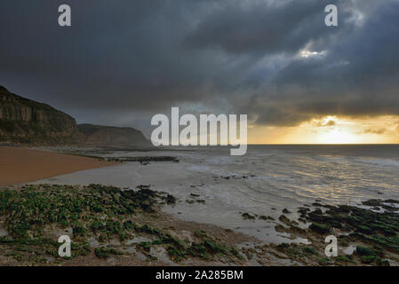 Storm clouds over the sandstone cliffs, Rock-a-Nore beach, Hastings, East Sussex, England, UK Stock Photo