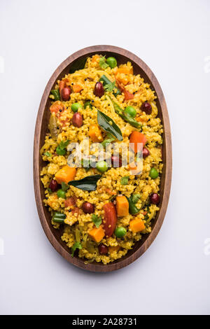 Broken wheat or Daliya Upma, served in a bowl. selective focus Stock Photo