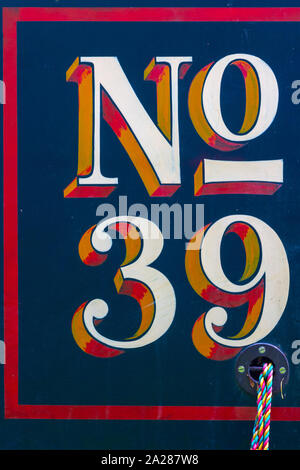 Number 39 painted in bright colors on the side of a narrow boat in the UK Stock Photo