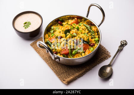 Broken wheat or Daliya Upma, served in a bowl. selective focus Stock Photo