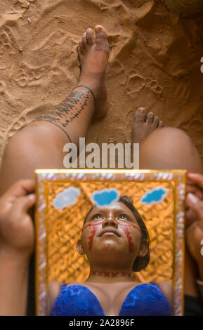 Reflection in a mirror of indigenous young woman Stock Photo