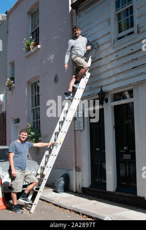 House painters with a ladder Stock Photo