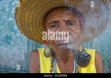 Senior Afro-Brazilian woman smoking pipe Stock Photo