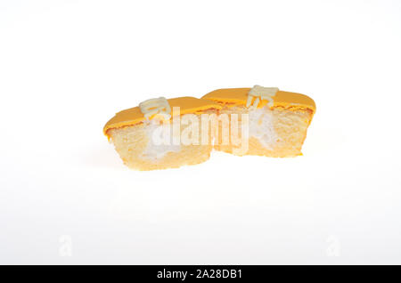 Hostess Frosted Orange Flavor Creme Filled Cupcake cut in half Stock Photo