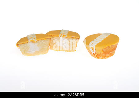 Hostess Frosted Orange Flavor Creme Filled CupCakes, 1 whole and 1 cut in half Stock Photo
