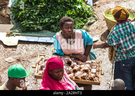 KAMPALA, UGANDA - OCTOBER 03, 2012.  A girl looks bored while selling food at the taxi park in Kampala, Uganda on October 03,2012. Stock Photo