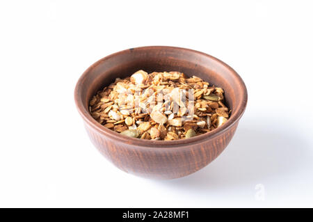 Clay bowl with granola. Granola in a brown plate. Stock Photo