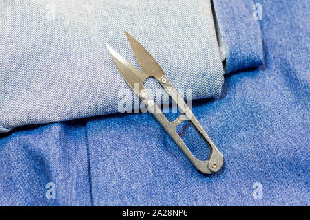 denim and scissors for cutting fabric Stock Photo