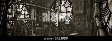 Vintage gravity driven clock tower mechanisms and dials. Stock Photo