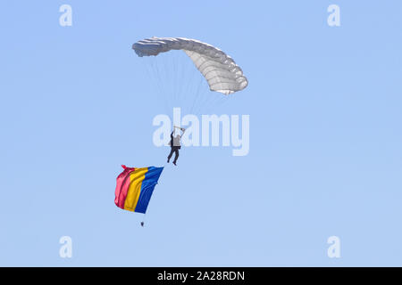 OSTRAVA, CZECH REPUBLIC - SEPTEMBER 22, 2019: NATO Days. Paratrooper descends after an airdrop over the airport, with Czech flag attached to him. Stock Photo