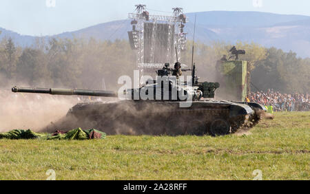 OSTRAVA, CZECH REPUBLIC - SEPTEMBER 22, 2019: NATO Days, battle for the airport. Old Russian T-72 tank speeds in the battlefield. Stock Photo