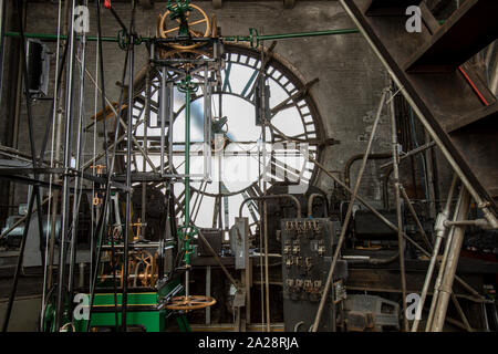 Vintage gravity driven clock tower mechanisms and dials. Stock Photo