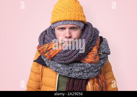 Handsome caucasian funny man in several hats and scarfs. Stock Photo