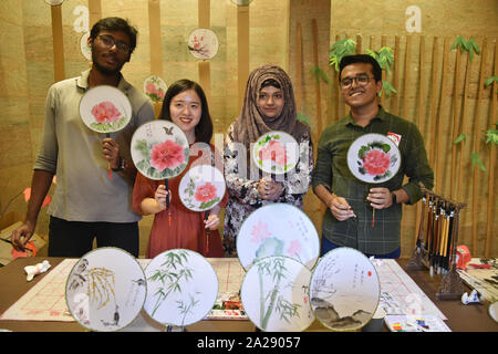 Dhaka, Bangladesh. 1st Oct, 2019. North South University students pose for photos with Chinese traditional fans in an event to celebrate the 70th anniversary of the founding of the People's Republic of China, in Dhaka, Bangladesh, on Oct. 1, 2019. Students of Bangladesh's North South University celebrated China's 70th founding anniversary with various cultural programs on Tuesday. Credit: Str/Xinhua/Alamy Live News Stock Photo