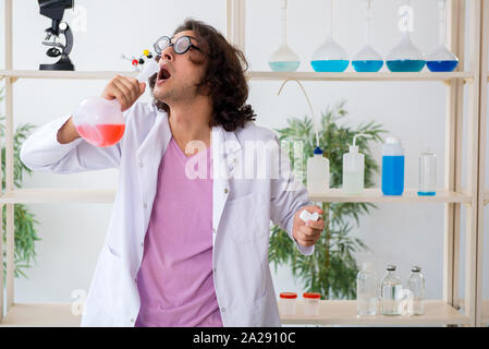 The funny male chemist working in the lab Stock Photo