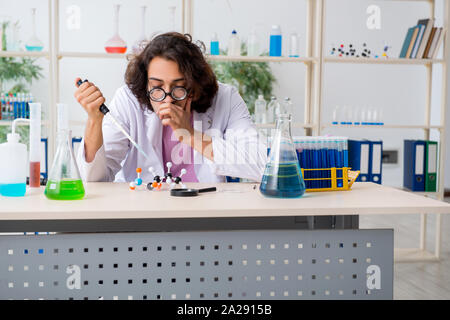 The funny male chemist working in the lab Stock Photo