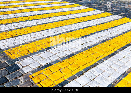 Pedestrian crossing with white and yellow stripes close up Stock Photo
