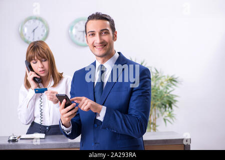 The young businessman at hotel reception Stock Photo