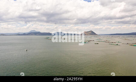 Lake Taal with a volcano and fish cages on a fish farm, top view. Luzon, Philippines Tropical landscape, mountains and volcano in the lake. Stock Photo