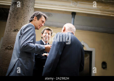 View of three men having a conversation. Stock Photo