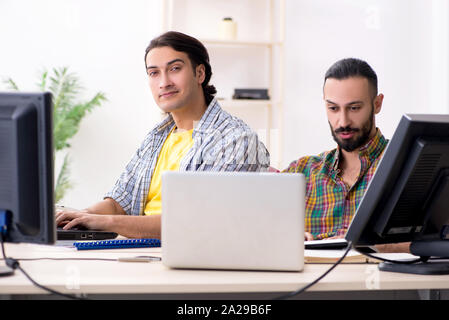 The two it specialists working in the office Stock Photo