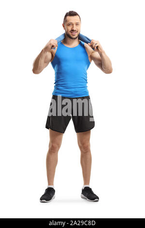 Full length portrait of a young muscular man in sportswear holding a towel around his neck isolated on white background Stock Photo