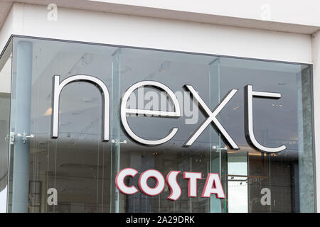 The exterior showing the sign or logo of a Next store and Costa coffee Stock Photo