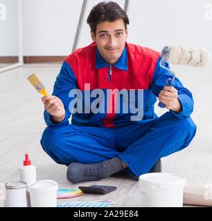 The young painter trying to match colours for painting job Stock Photo