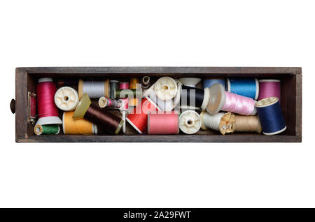 Thread bobbins in drawer box isolated on white background Stock Photo