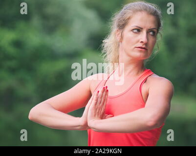 Woman in her Thirties Doing Yoga in the Park Closeup Stock Photo