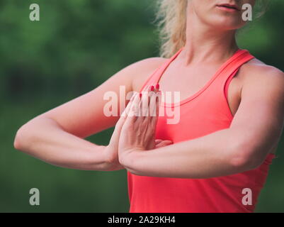 Woman in her Thirties Doing Yoga in the Park Closeup Stock Photo