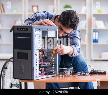 The computer repairman on wheelchair working Stock Photo